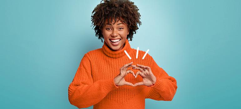 girl making a heart shape with her fingers