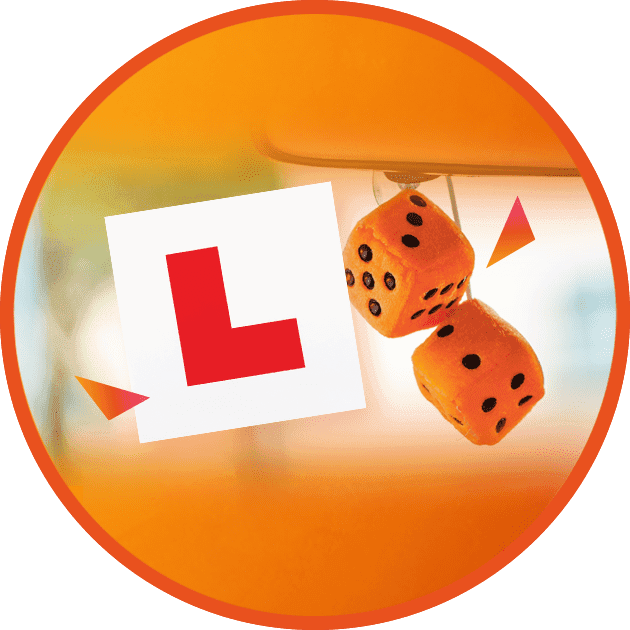 L plate in window with dice in car
