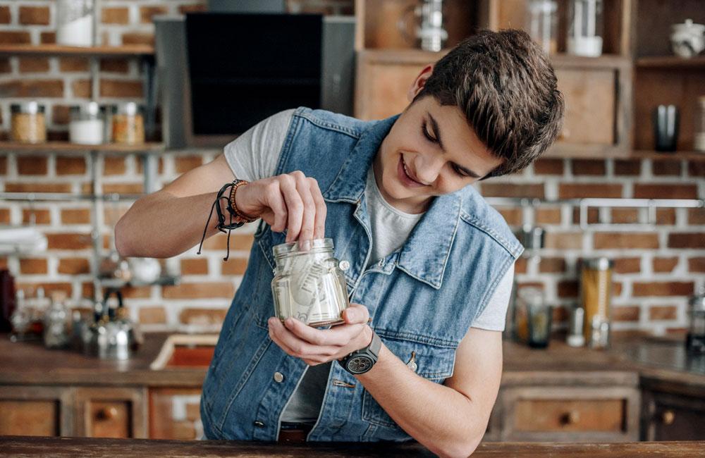 Boy saving money in jar